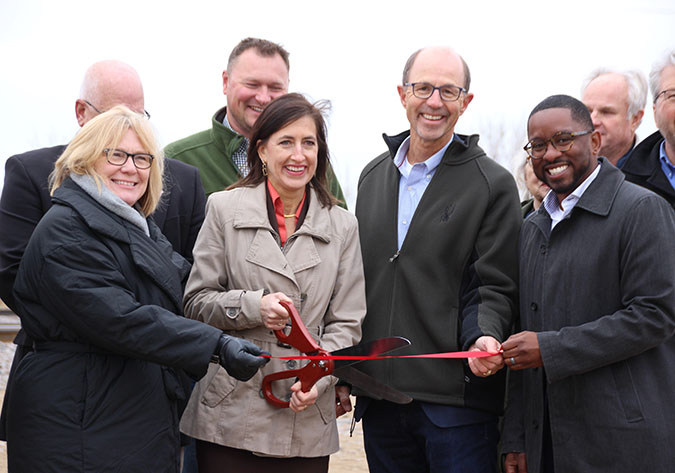 Officials attend the ribbon-cutting ceremony for the bypass project. Front row from left to right, U.S. Rep. Michelle Fischback, Minnesota Department of Transportation Commissioner Nancy Daubenberger, Kandiyohi County Public Works Director Mel Odens, and BNSF General Director Public Investment French Thompson.